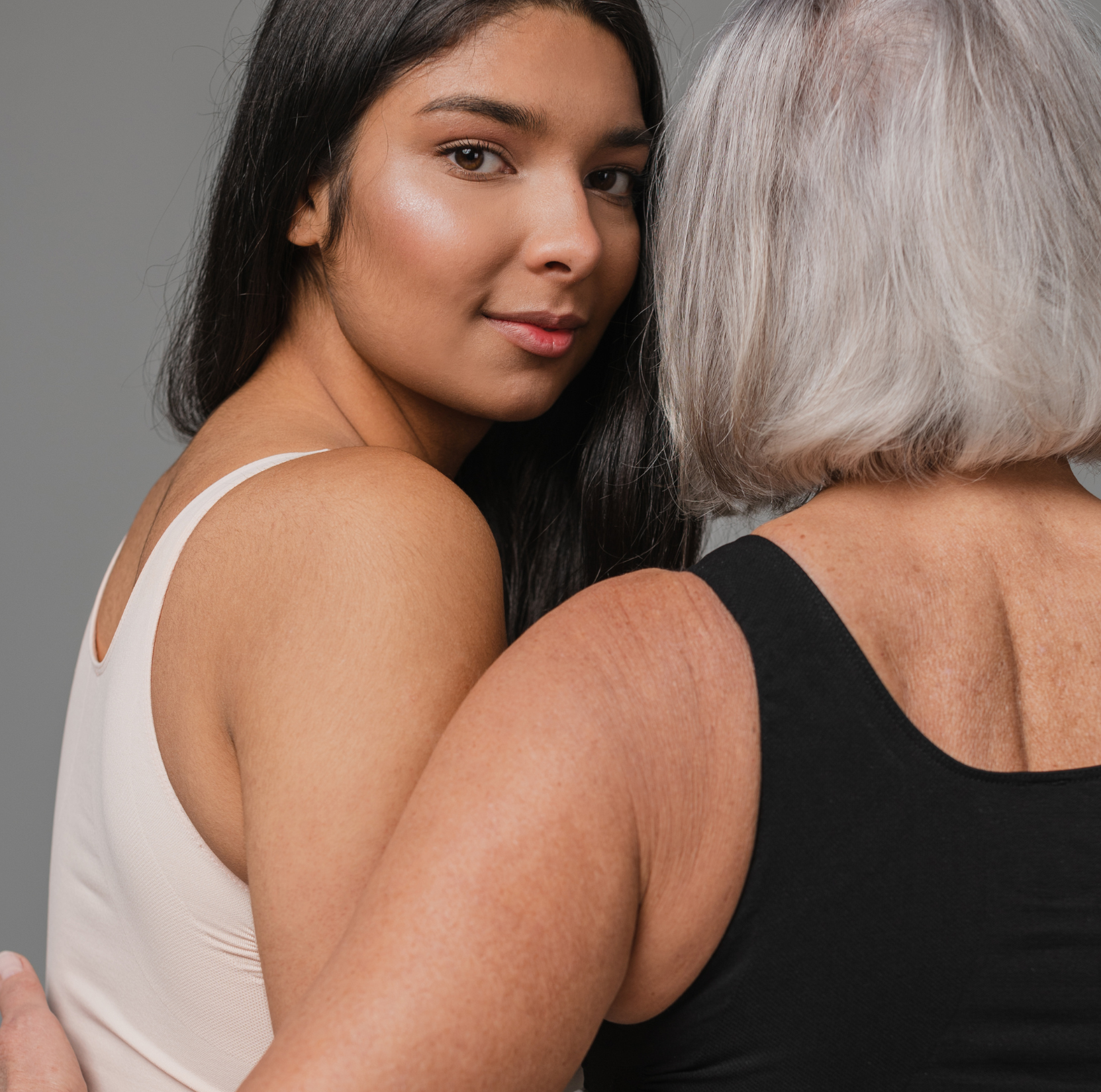 Young and mature woman together, representing lifelong women’s health and support at Thrive Women’s Care.